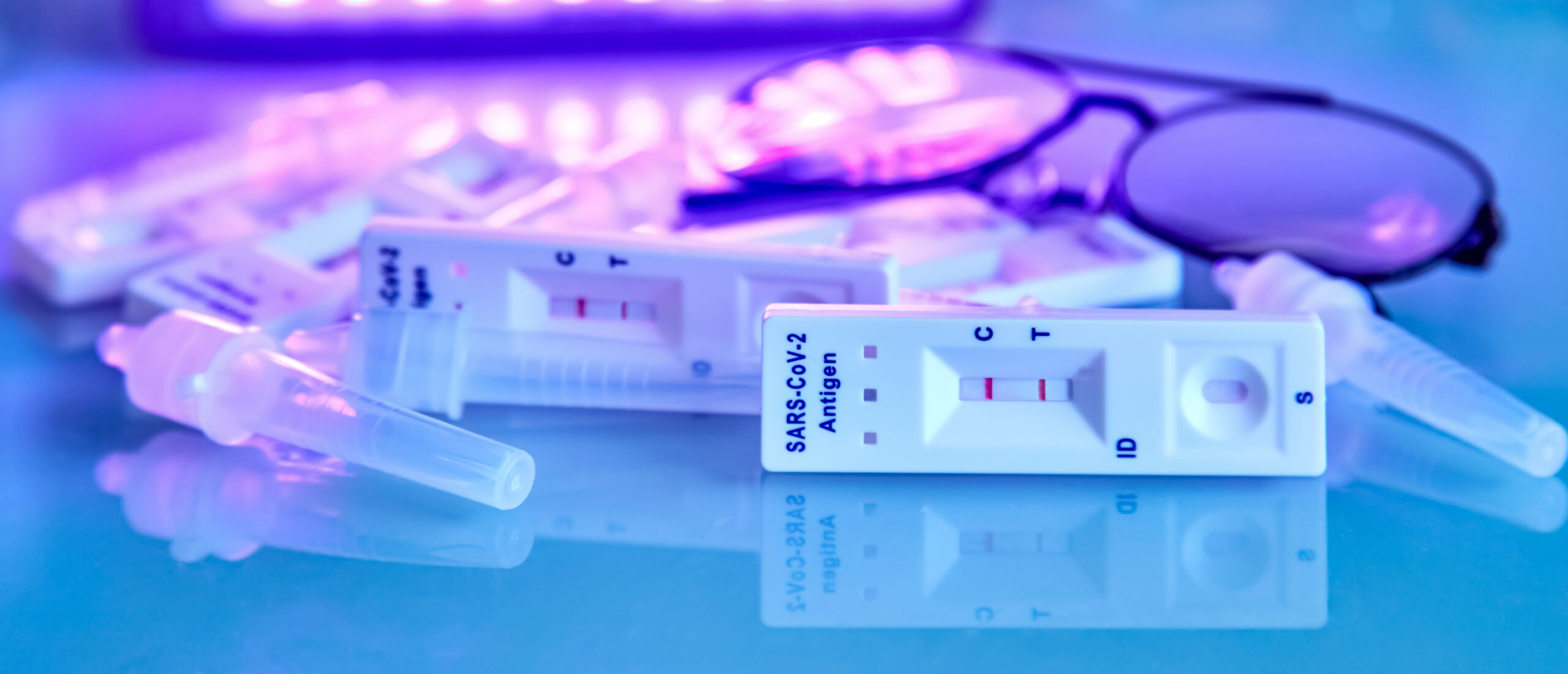 6 covid-19 antigen self-tests positive, buffer bottles and thin black-rimmed glasses on a light background. Self test. test at home. Corona, Covid 19, coronavirus SARS-CoV-2 flu disease pandemic